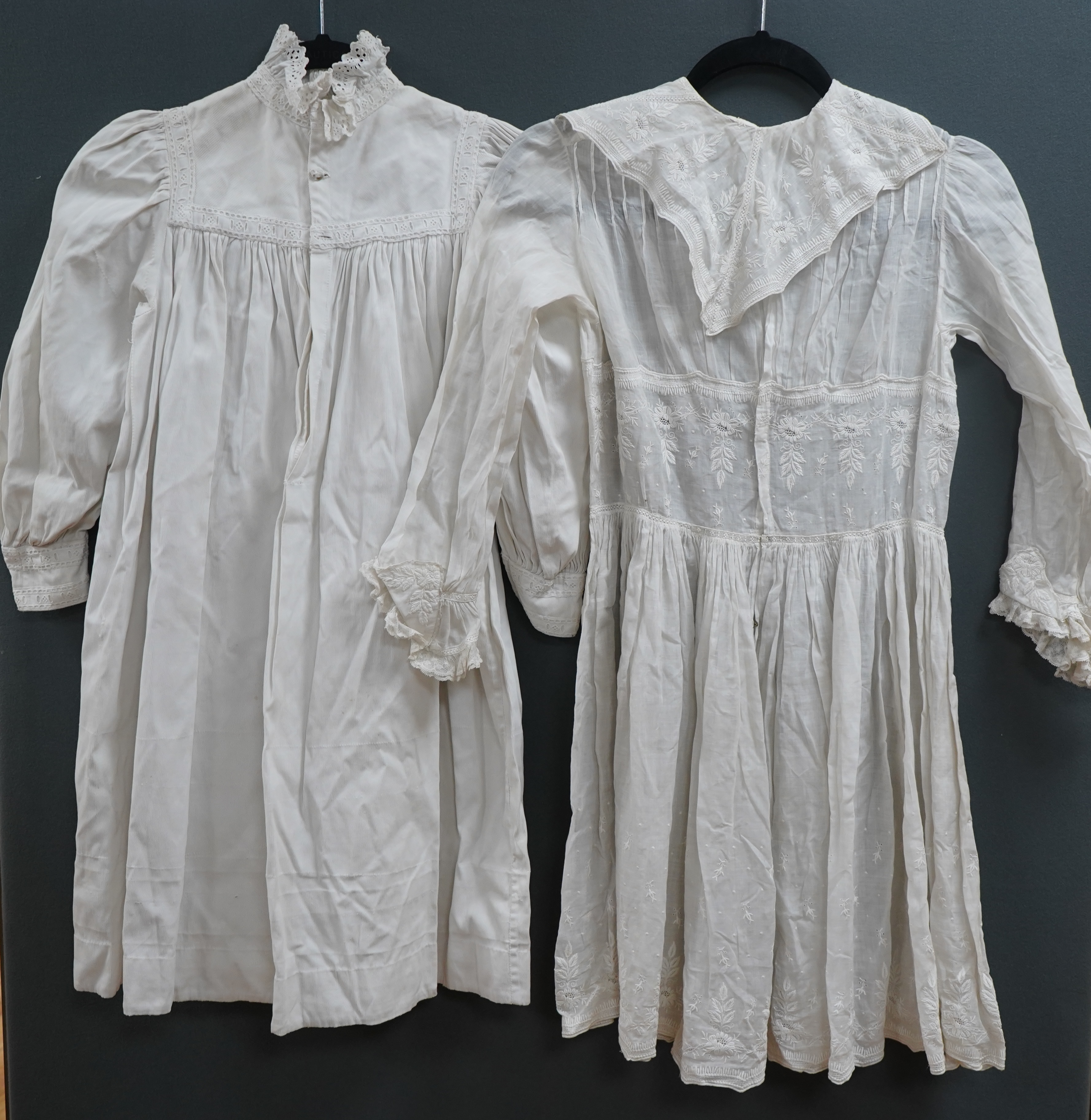 Two late 19th early 20th century girls summer dresses, one fine cotton with white worked collar cuffs and bodice, the other a cotton twill with anglaise collar large puff sleeves and gathered across the chest, lawn dress
